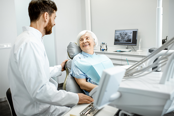 Older women in dental chair - Benefits of Dental Implants